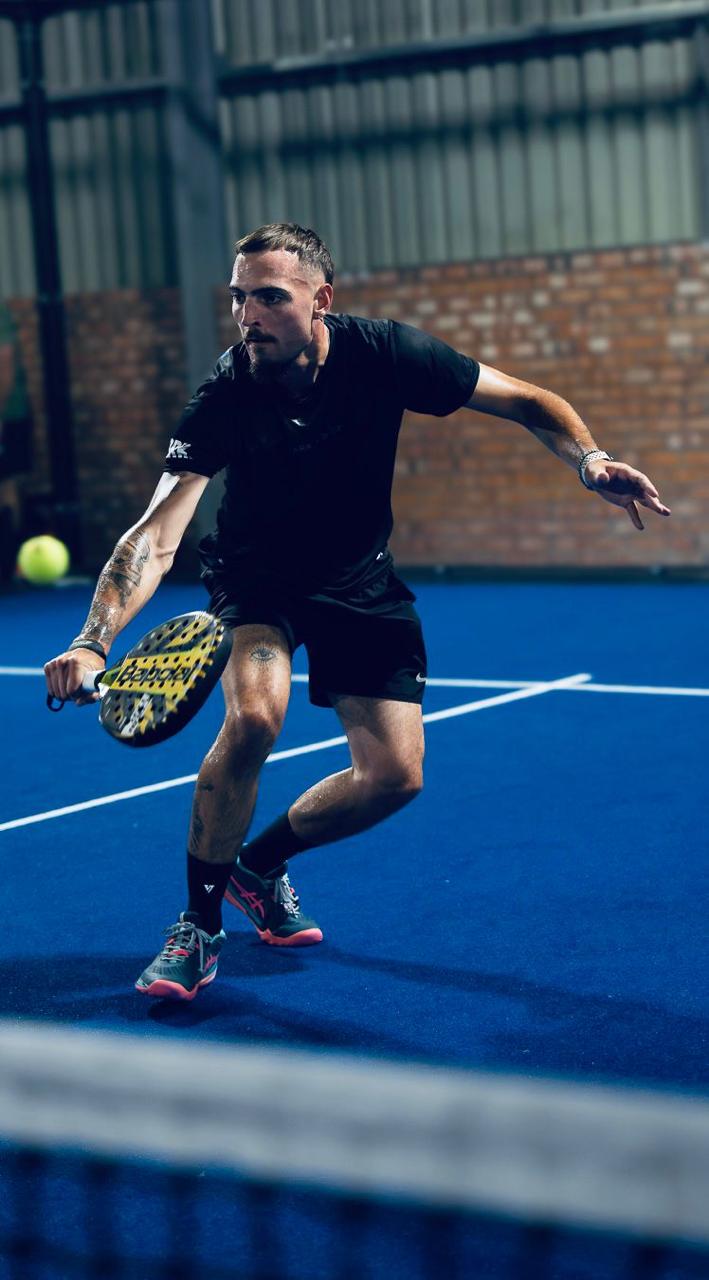 Diego coaching from the padel court